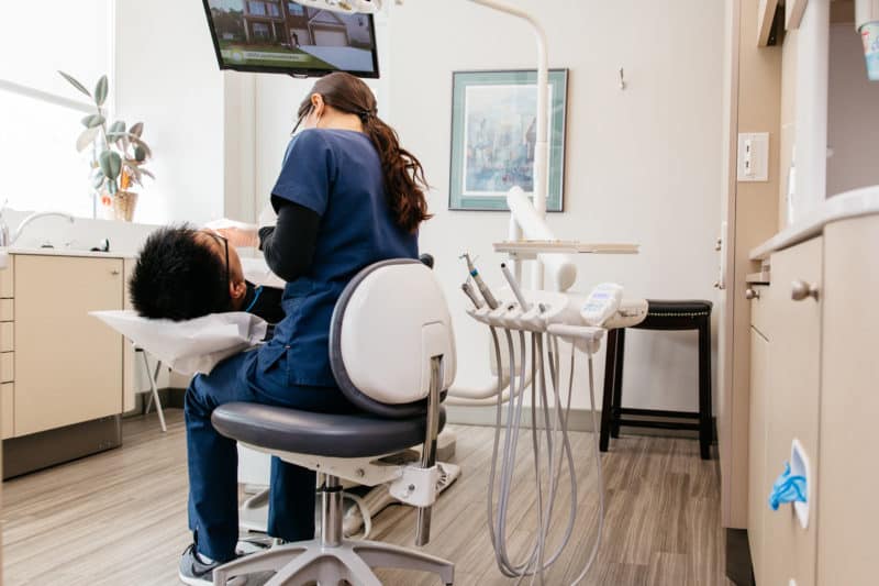 A PoloPark Dental staff member working with a patient